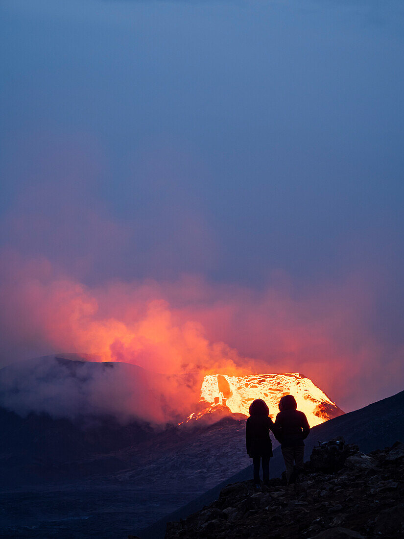 Couple enjoys eruption of Fagradalsfjall Volcano from Observation Hill, Iceland