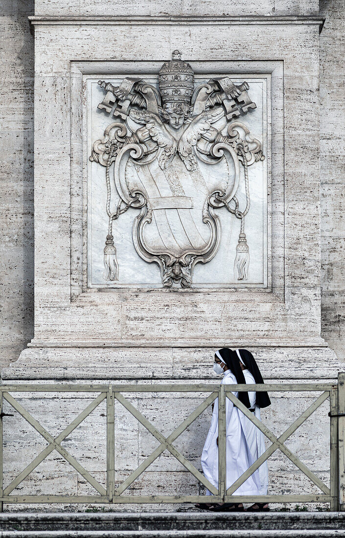 Nuns in front of the Facade at Basilica di San Giovanni in Laterano Rome Italy