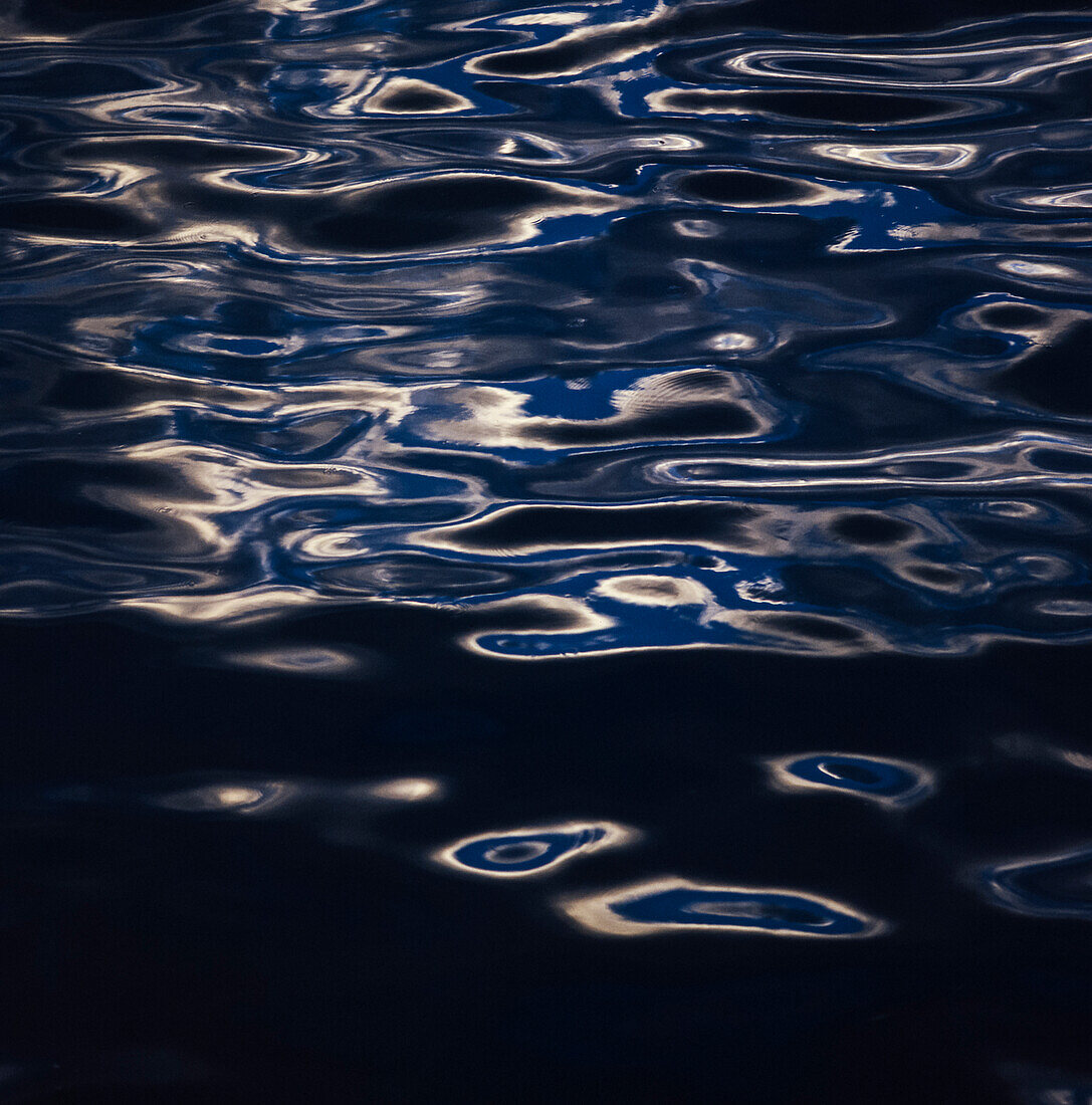 Light shining on gentle ripples in water