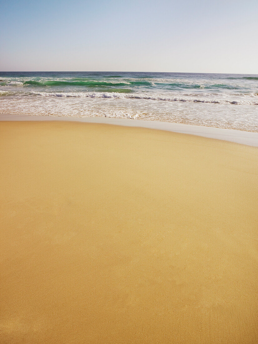 Gentle waves rolling onto beach