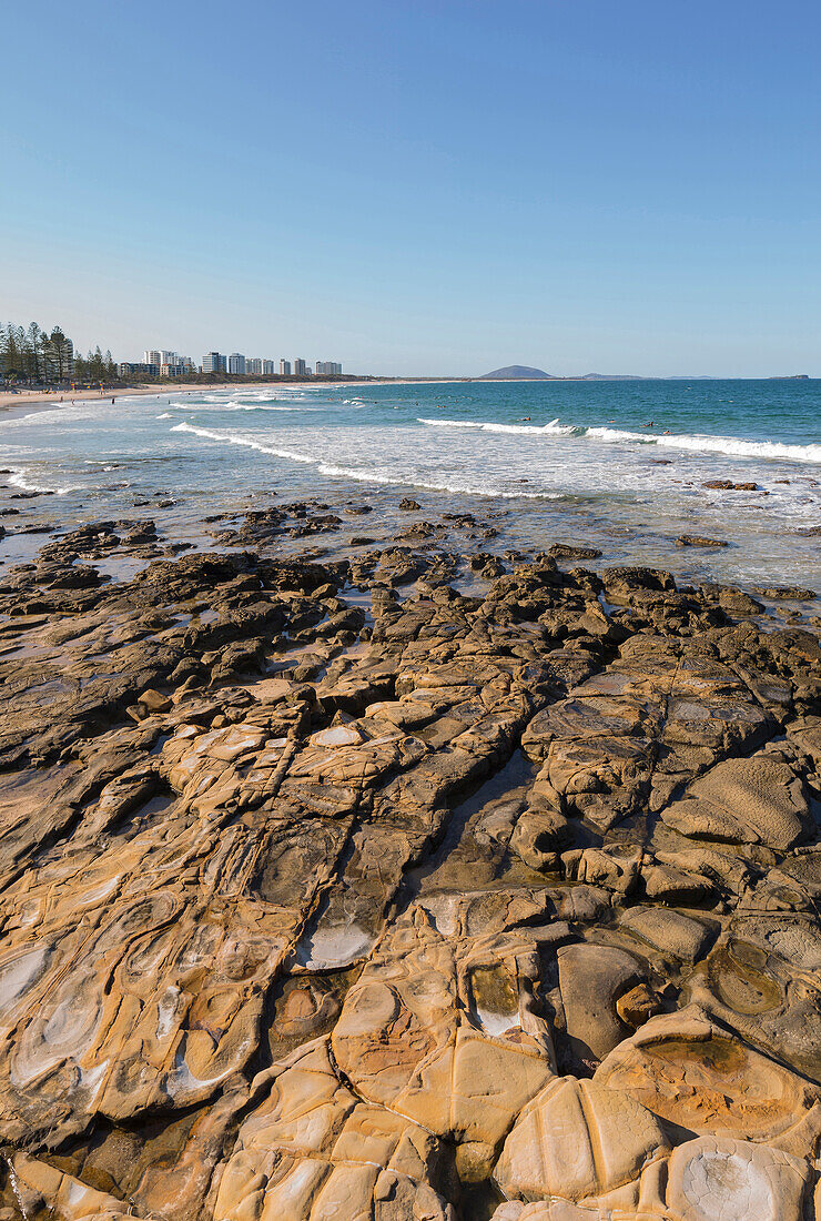 Looking across rocks and waves from Mooloolabah to Maroochydore