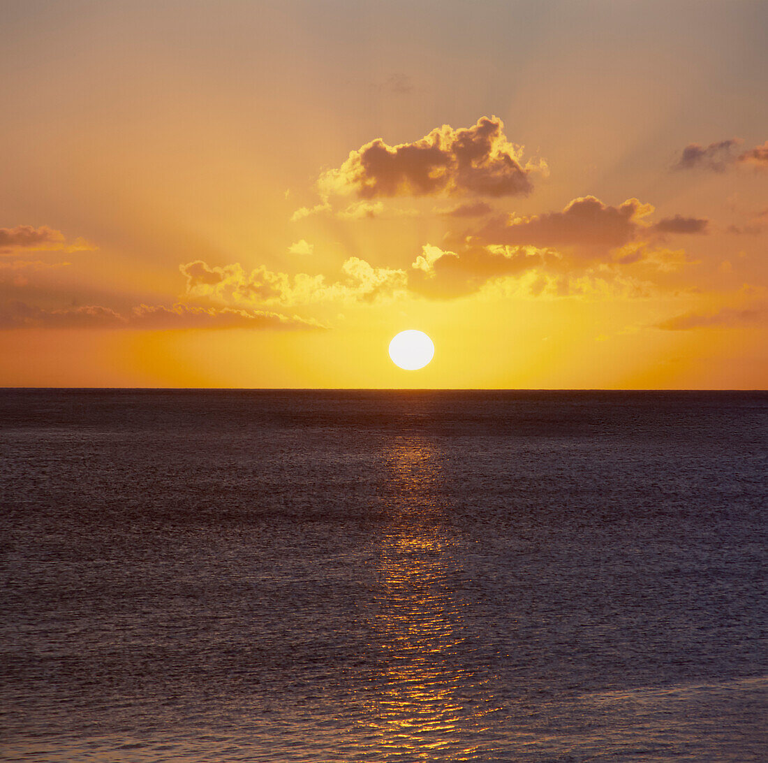 Sun setting over the calm ocean in Guam