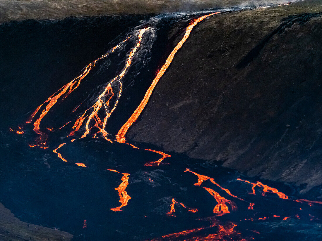 Glowing Lava cascade flowing steeply downhill, Fagradalsfjall Volcano, Iceland