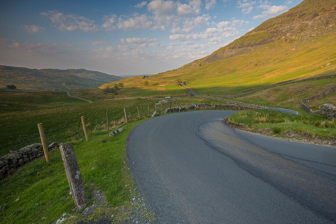 Winding small road in Cumbrian mountains, Lake District, England.