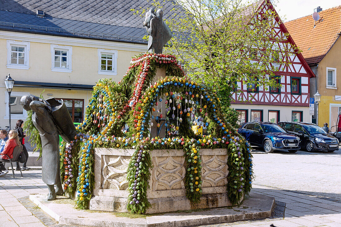Easter fountain decorated with colorful Easter eggs in Ebermannstadt on the market square in Franconian Switzerland, Bavaria, Germany