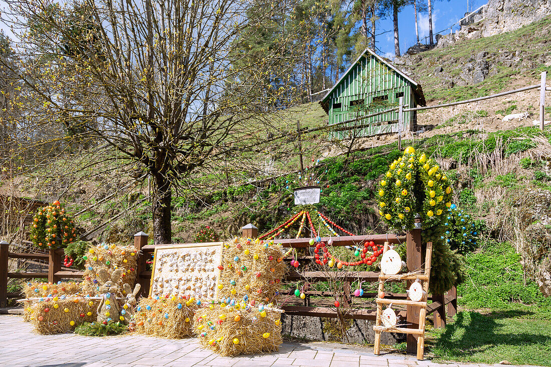 Easter spring decorated with colorful Easter eggs at the Trubachquelle in Obertrubach in Franconian Switzerland, Bavaria, Germany