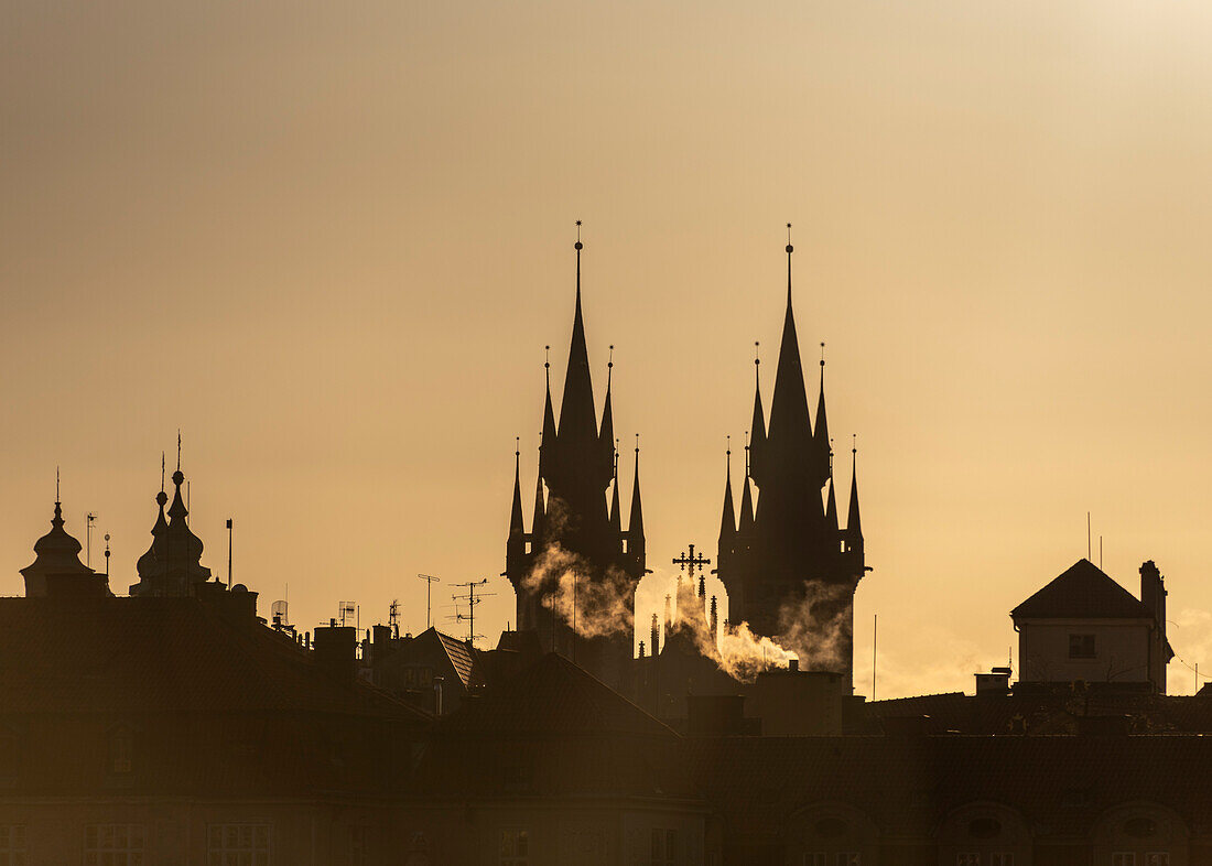 Sunrise, smoking chimneys, Tyn Church, Prague, Czech Republic