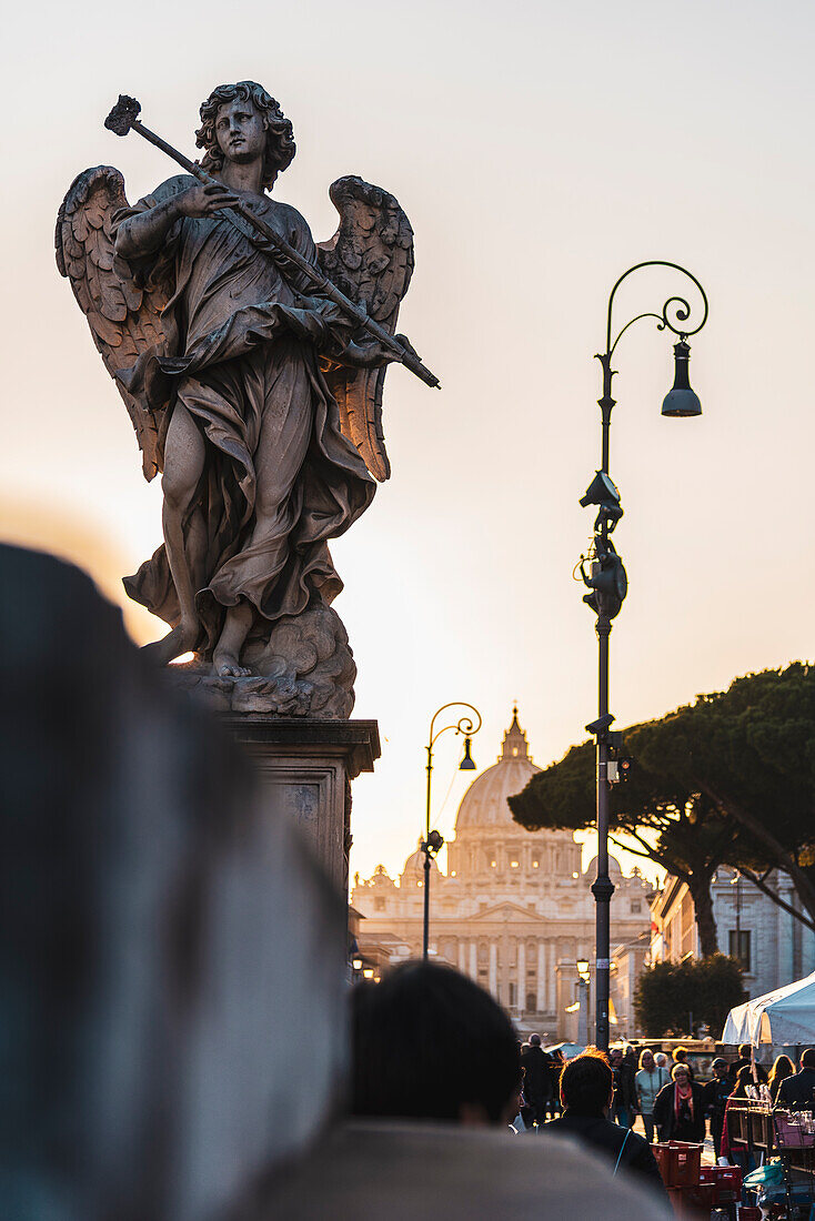 Angel figure on the Ponte Sant'Angelo, on the Lungotevere Castello overlooking St. Peter's Basilica, Rome, Lazio, Italy, Europe