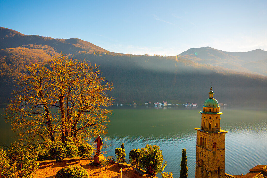 Church Tower Santa Maria del Sasso with Sunlight and Mountain on Lake Lugano in Morcote, Ticino in Switzerland.
