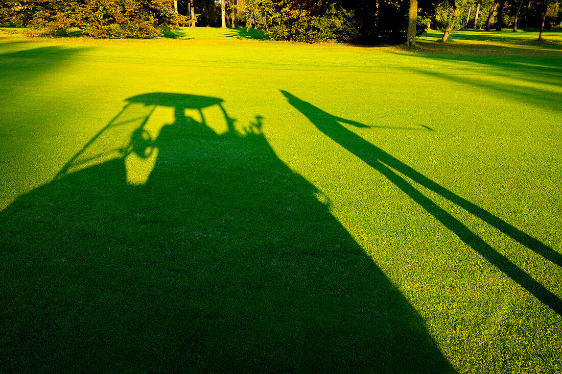 Shadow of Golfer and Golf Cart on Golf Course in Lugano, Switzerland.