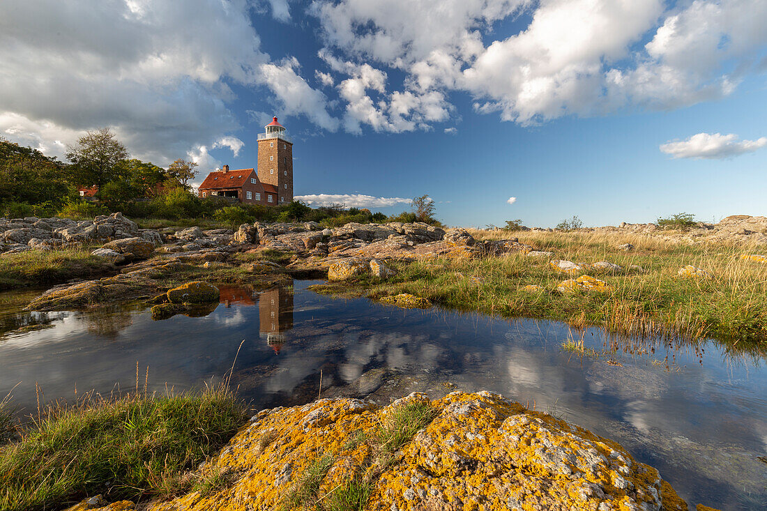 Svaneke Gamle Fyr Lighthouse with reflection in the water, Svaneke, Bornholm, Denmark