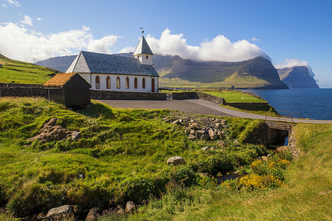 Vidareidi Church on Vidareidi, Faeroes. Shoreline, Cliffs, Sunny.