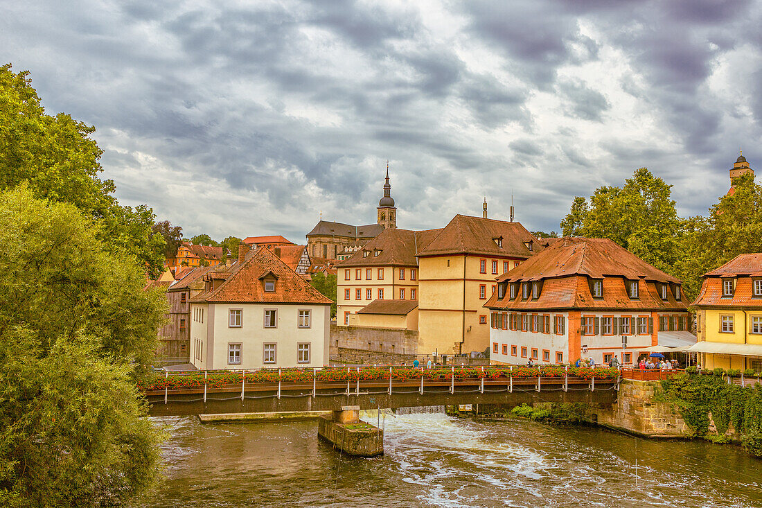 Half-timbered houses and pedestrian bridge over the Regnitz River in Bamberg, Franconia, Germany