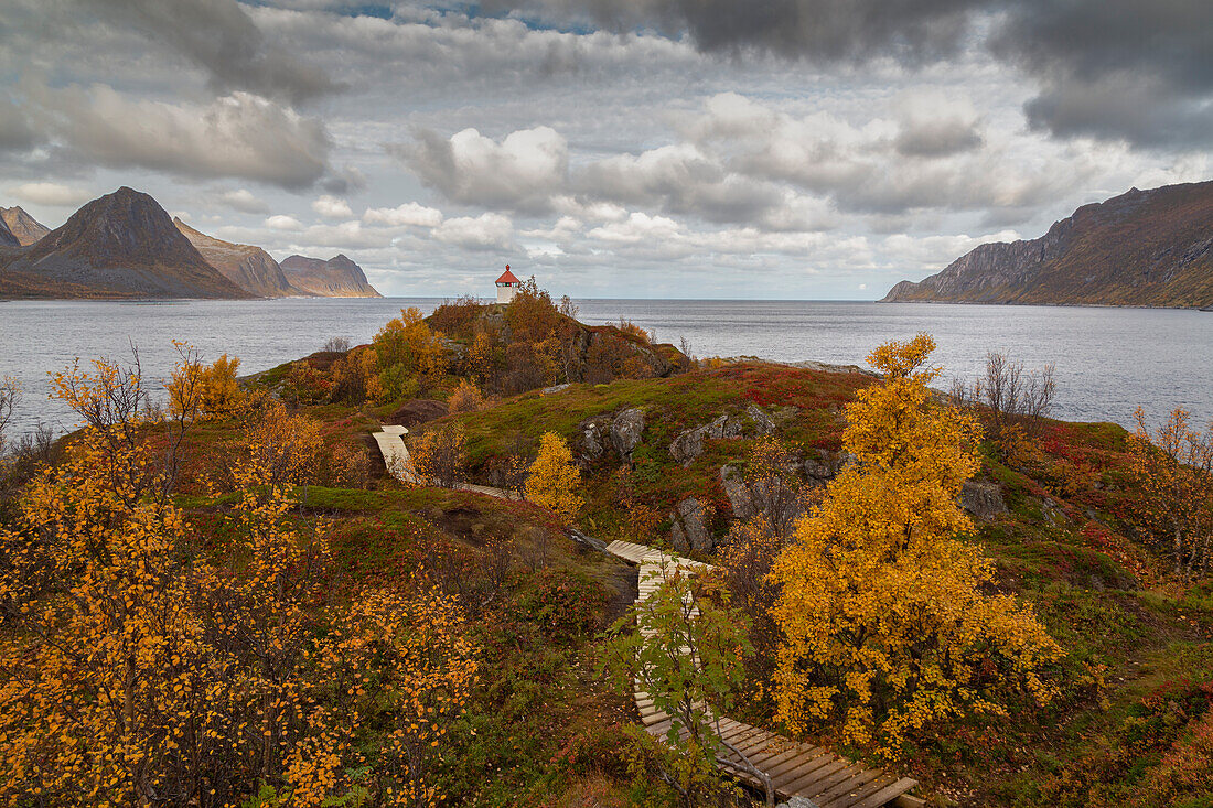 Lighthouse on autumnal headland of Husoy, Senja, Norway.