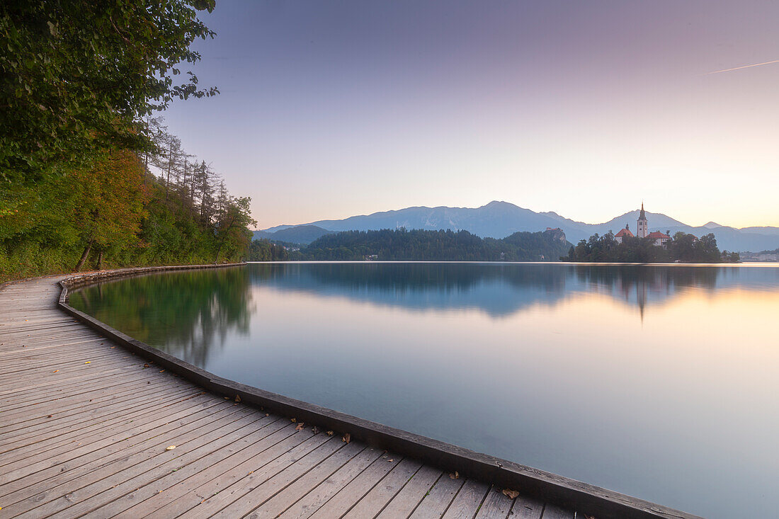 Church of the Mother of God on island at Lake, Bled, Slovenia. Jetty in the foreground. Reflection.