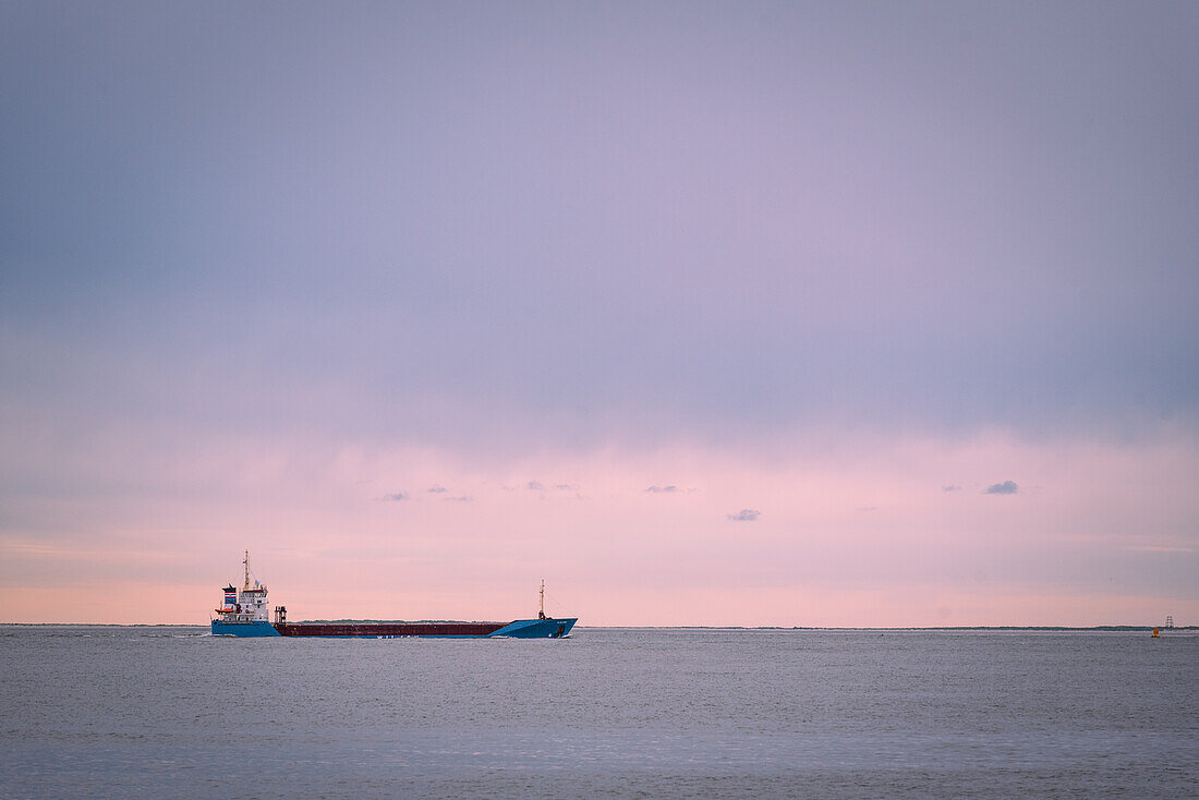 Cargo ship in the evening light off Borkum, Lower Saxony, Germany