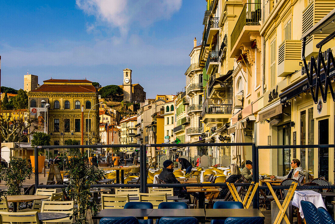 Rue Felix Faure in Cannes with a view of the town hall and the towers of the old town in the morning, Alpes-Maritimes department, France