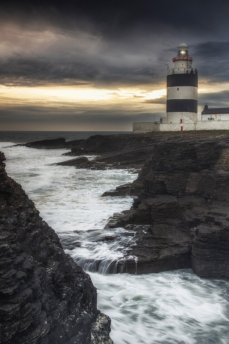 Hooks Head lighthouse on cliffs in stormy seas. After sunset. Churchtown, County Wexford, Ireland.tif