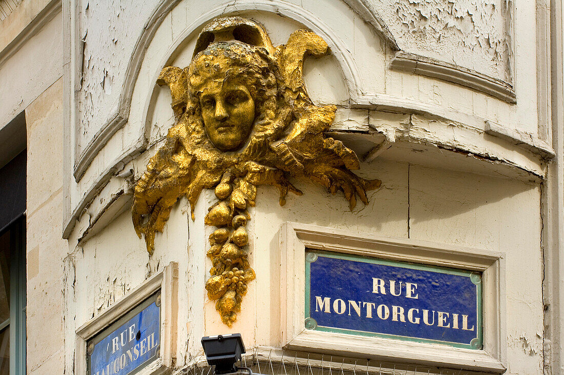 Gold head and details on the corner of Rue Montorgueil, Paris, France