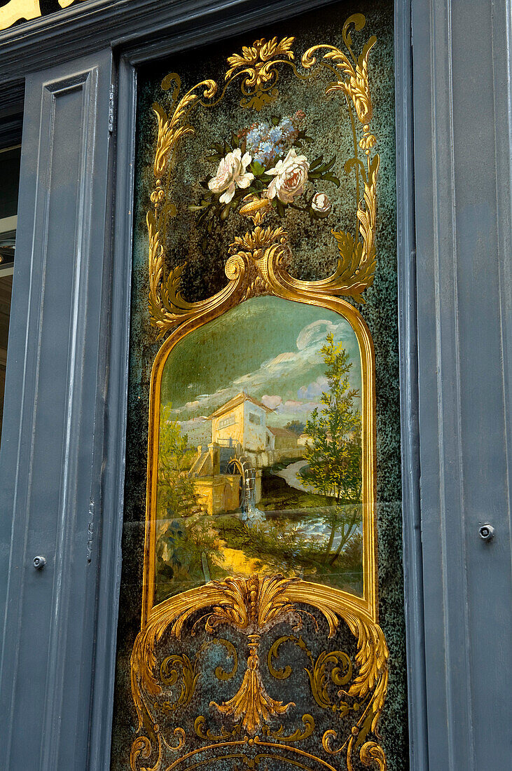 Gold framed Mural in Rue des Francs Bourgeois showing a mill and flowers, Marais