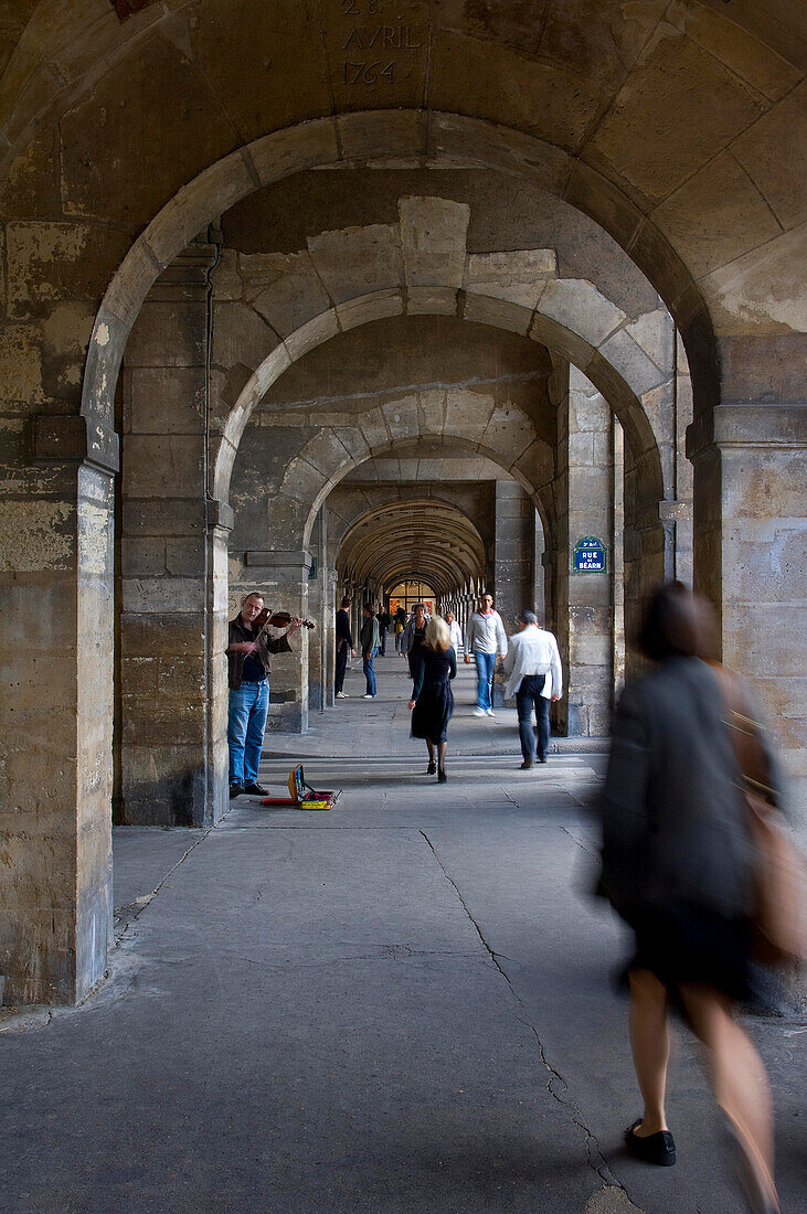 Busker playing the Violin in the Cloisters at Place des Vosges, The Marais, Paris, France