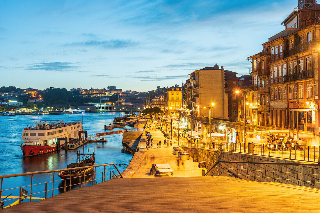 Night shot of the Cais de Ribeira waterfront promenade and the historic old town of Porto, Portugal