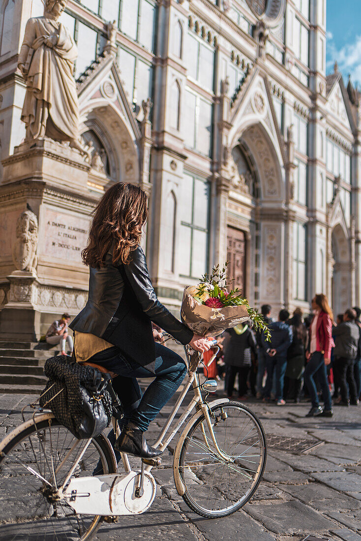 Statue of Dante Alighieri, woman with bicycle in front of facade of Santa Croce Church, Franciscan Church, Florence, Tuscany, Italy, Europe