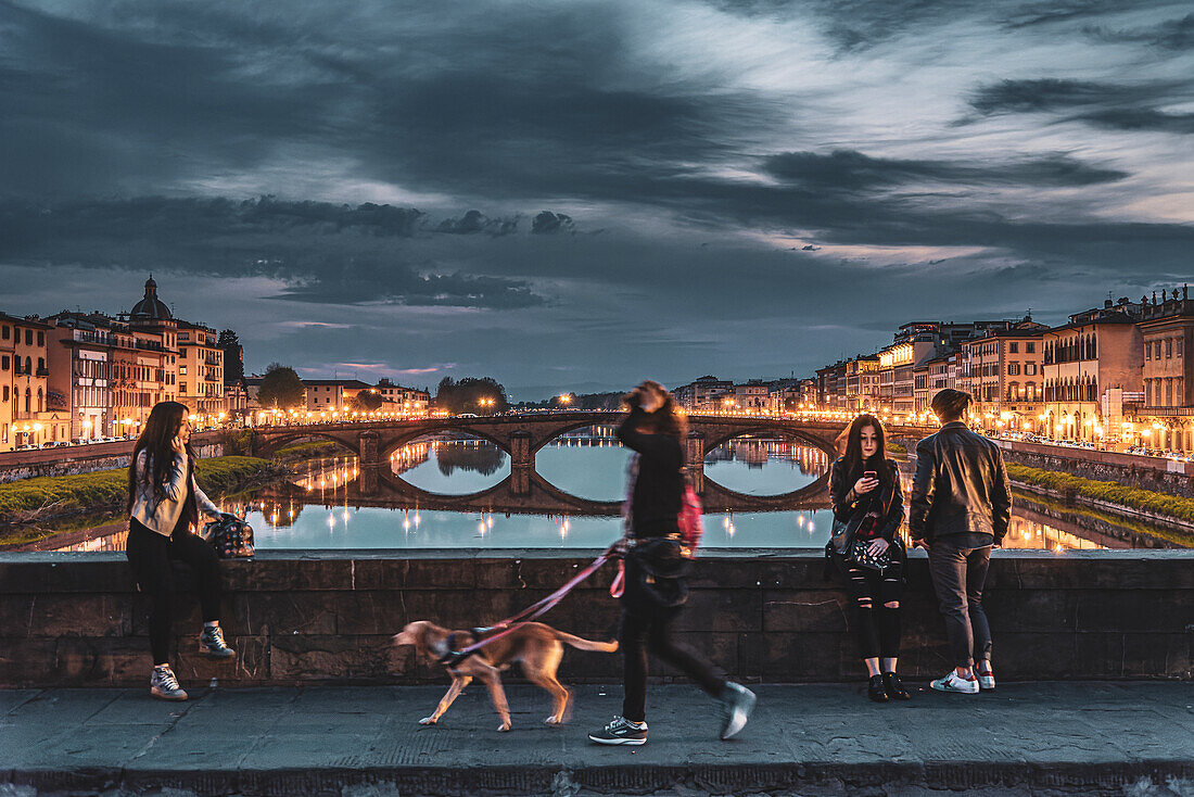 Woman with dog, people enjoying evening mood, bridge over Arno, Florence, Tuscany, Italy, Europe