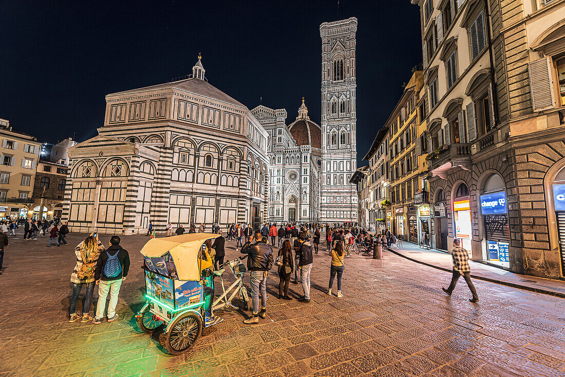 Cycle rickshaw, people in the evening in front of Baptistery and facade of Duomo, Cathedral of Santa Maria del Fiore, Florence, Tuscany, Italy