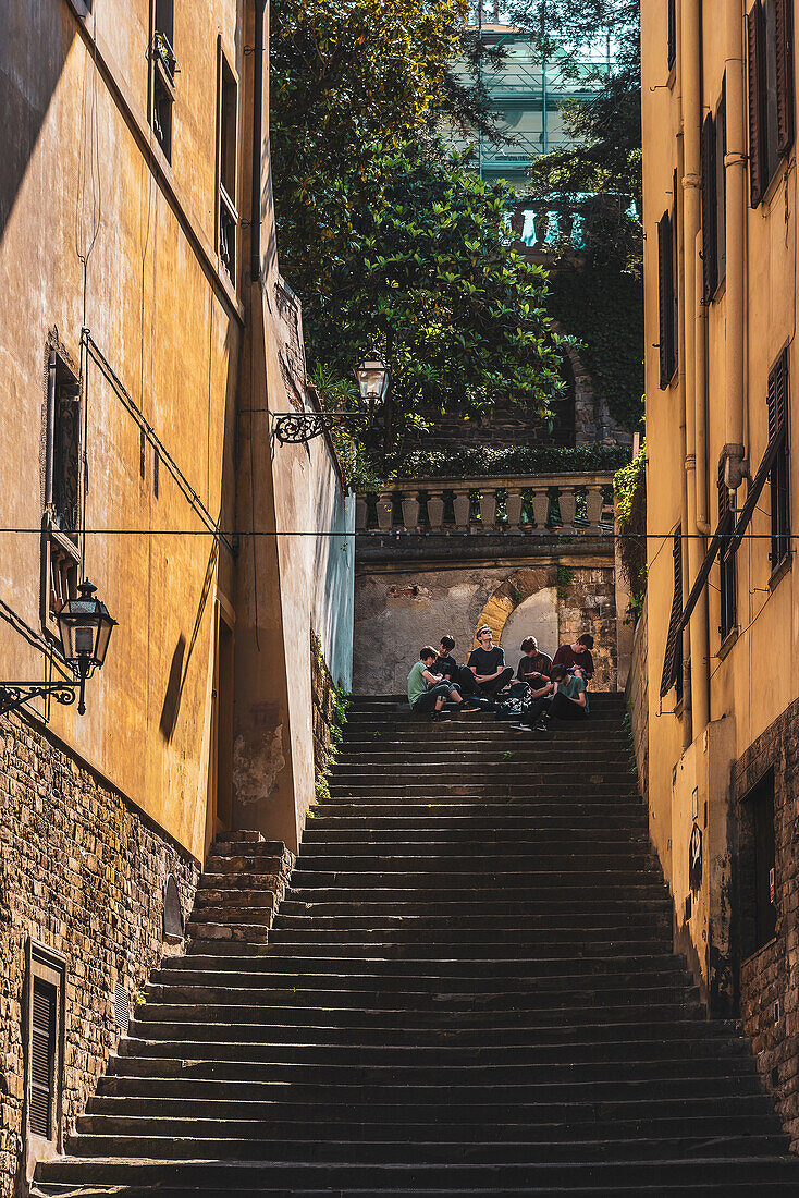 Young people at the bottom of a long staircase, Florence, Tuscany, Italy, Europe