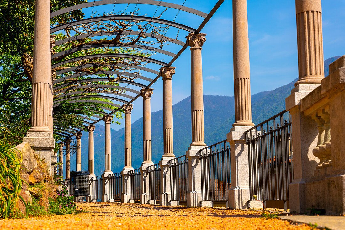 Walkway with Column and Arch with Mountain View in a Sunny Day in Lugano, Ticino, Switzerland.