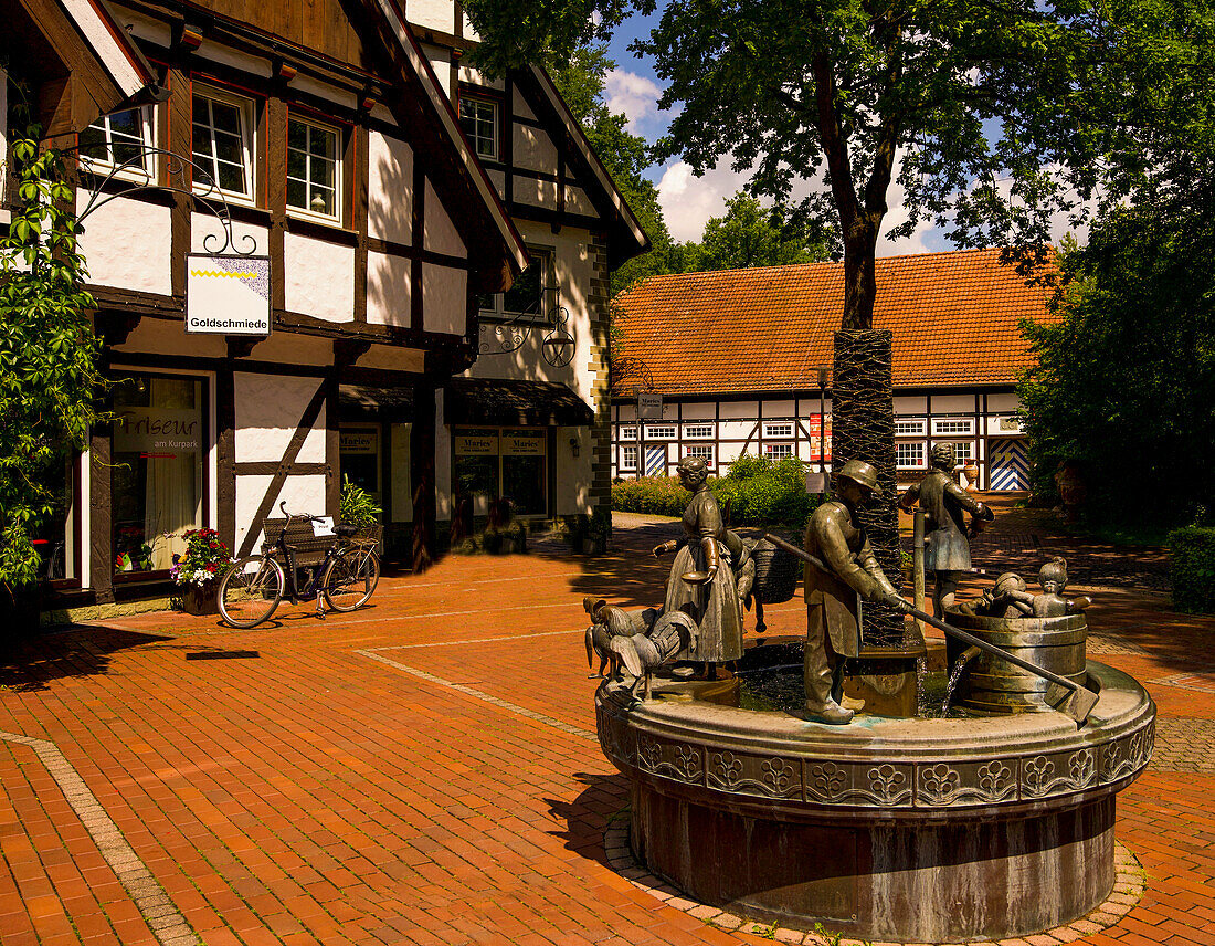 Bonifatius fountain and half-timbered houses on Karl-Bolke-Platz in Bad Sassendorf, Soest district, North Rhine-Westphalia, Germany