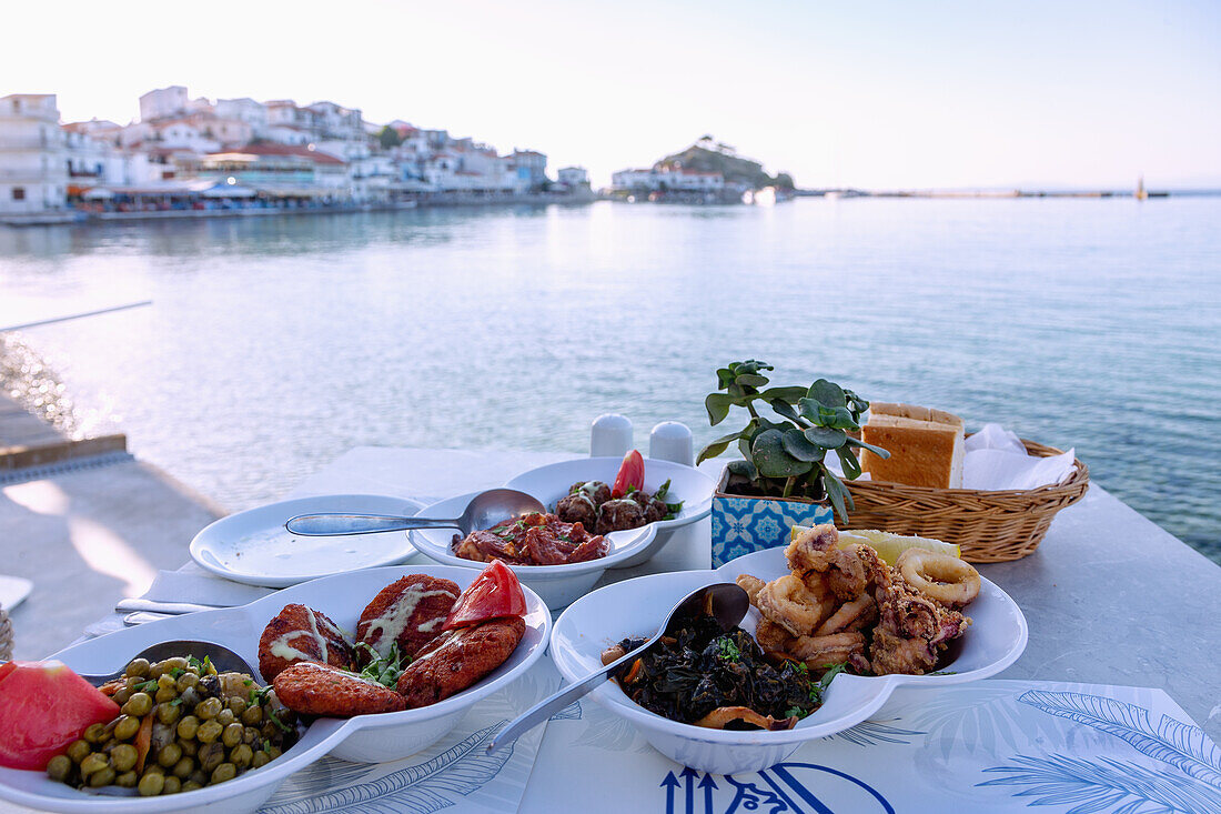 Greek meze with meat, squid and vegetables at the Poseidon restaurant in Kokkari on the island of Samos in Greece