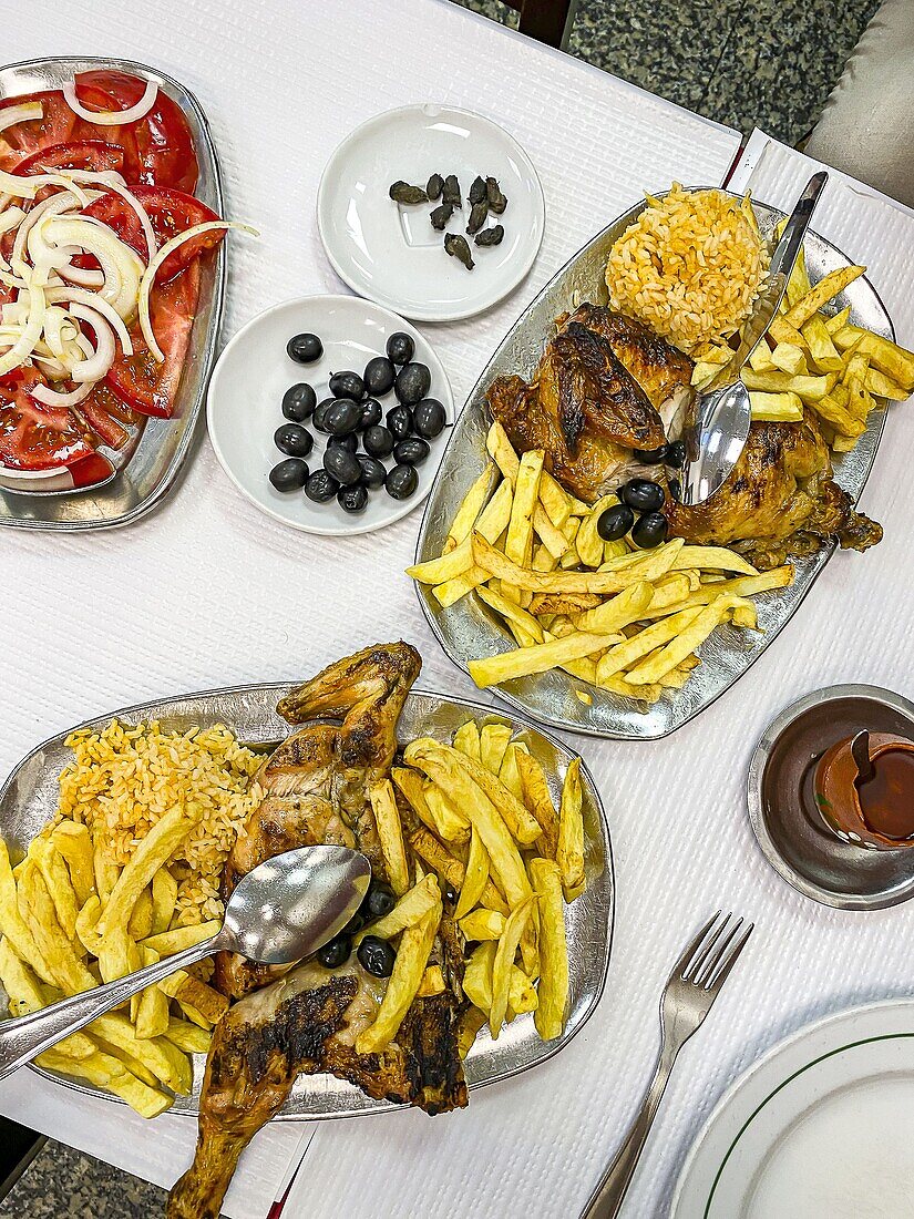 Traditional Portguese Peri Peri Chicjen with Rice, Fries and Tomato Salad