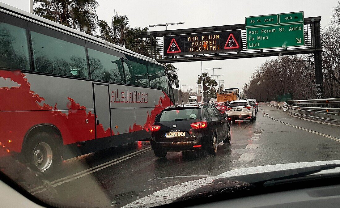 Cars and bus traffic on a rainy day travelling towards Barcelona on the Highway. Barcelona. Cataluna. Spain