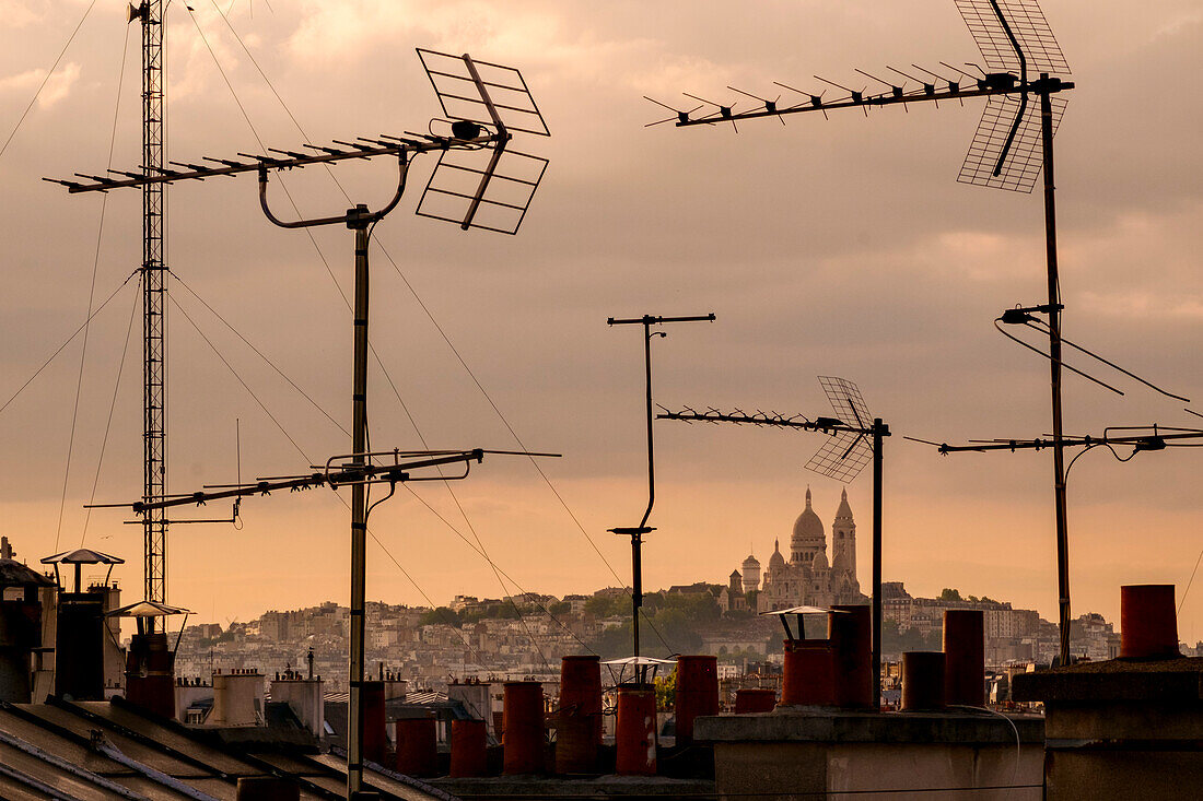 Sacré-Cœur Basilica viewed through television aerial antennae and apartment rooftops, Paris, France