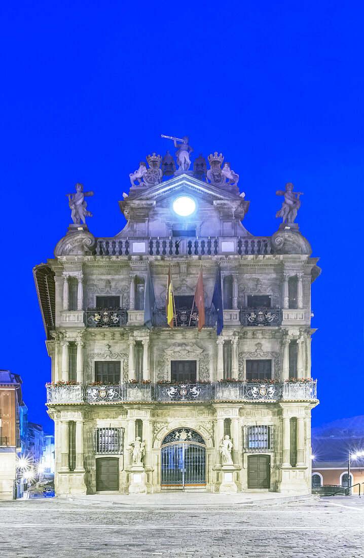 Pamplona City Hall lit up at dusk, Spain