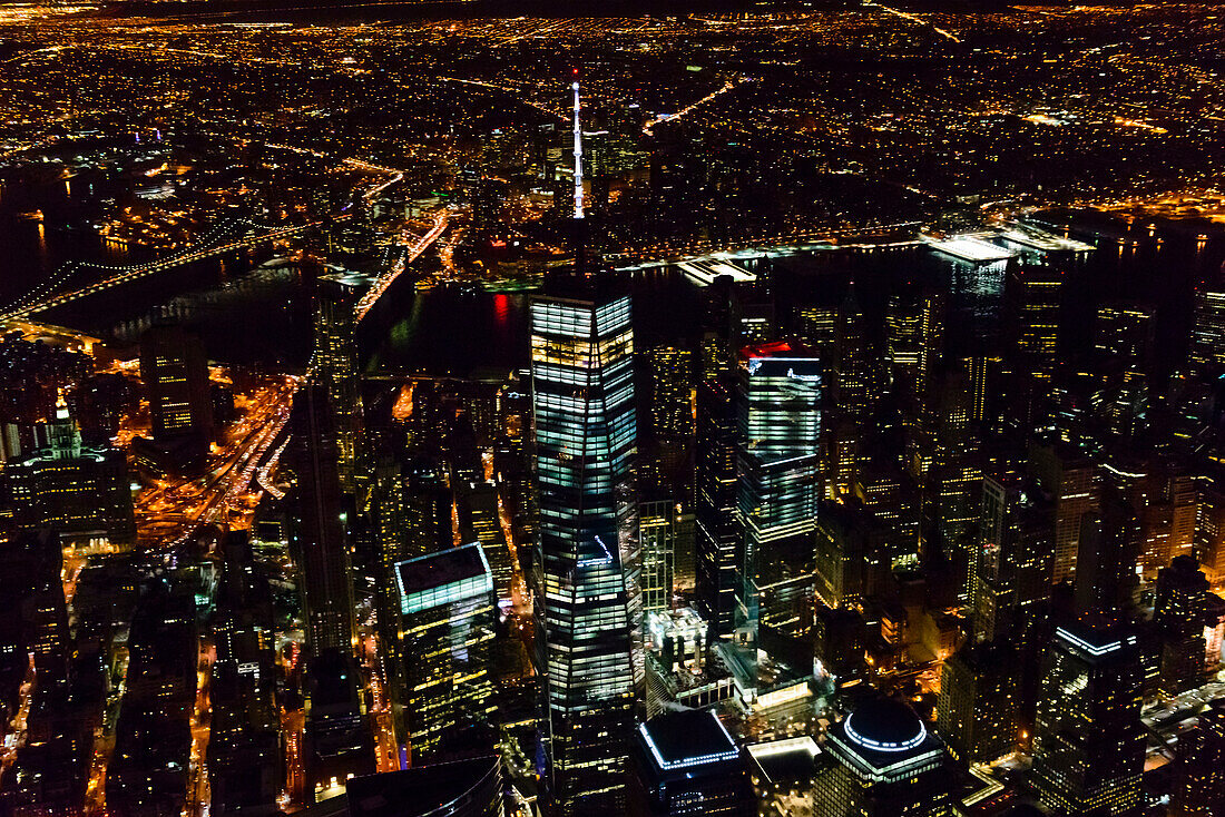 The city of New York City, Manhattan, aerial view at night.