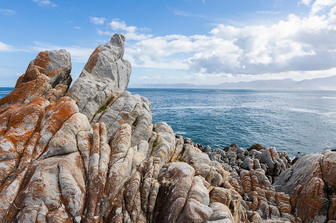 Jagged rocks on the Atlantic coast, waves on the water surface.