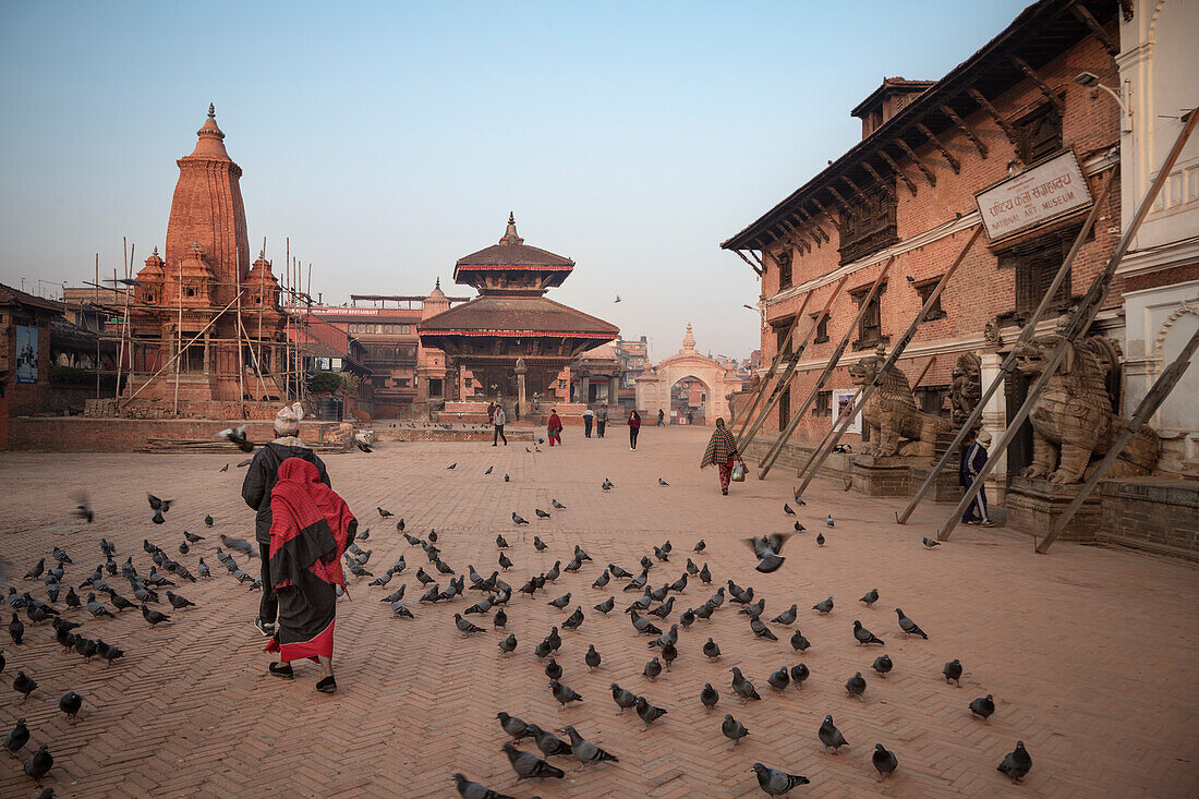 Pigeons, tumbledown temples and Royal Palace, Bhaktapur, Durbar Square, Lalitpur, Kathmandu Valley, Nepal, Himalayas, Asia, UNESCO World Heritage Site