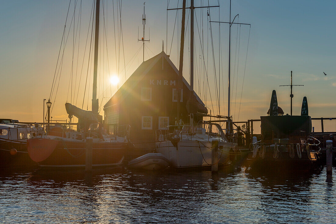 Sunset with sailing boats, harbour, Marken peninsula, near Amsterdam, North Holland, Netherlands