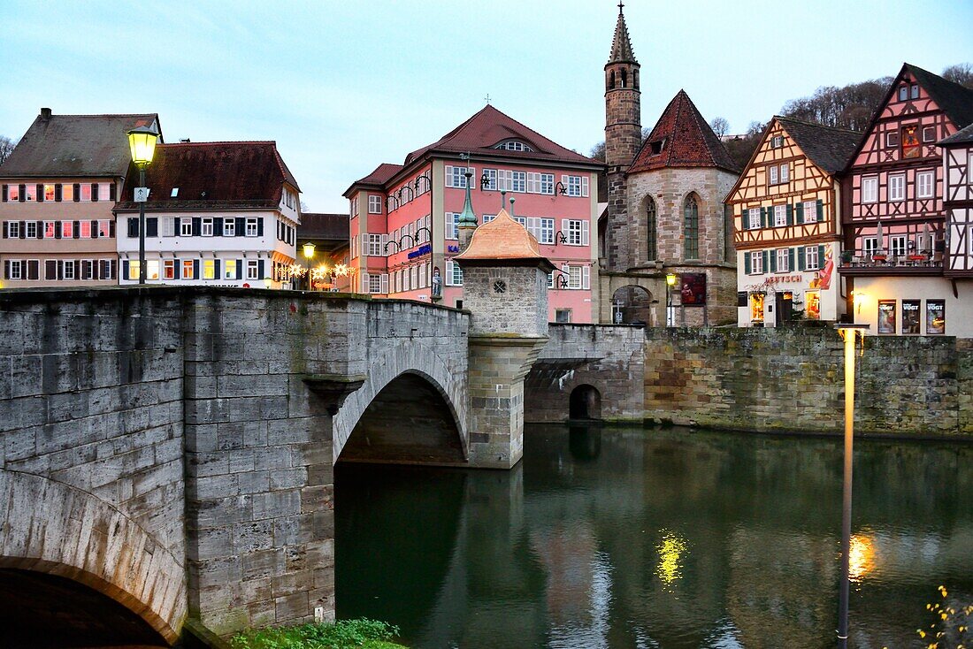 Henkerbrucke - Henker bridge over Kocher river,traditional historic half-timbered townhouses and church Johanniterkirche in background,historic part of Schwabisch Hall,northeast of Baden-Wurttemberg,Germany,Europe