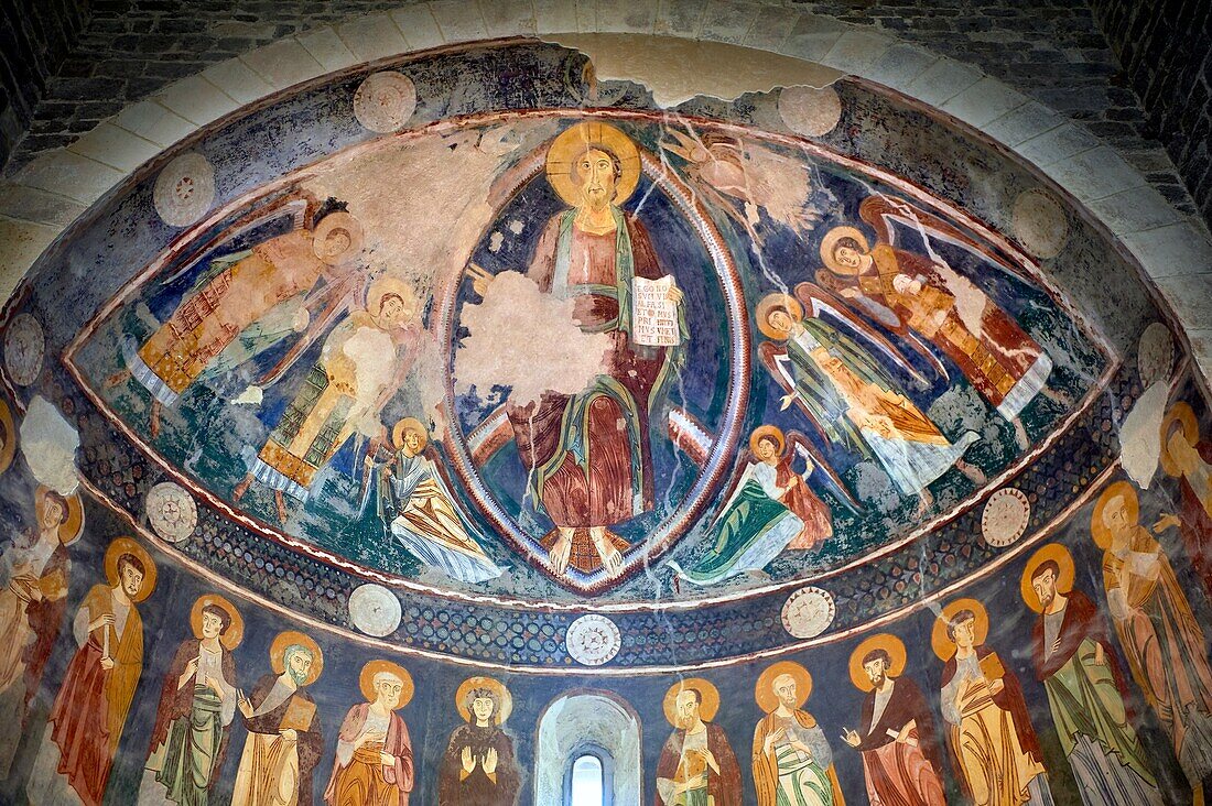 Interior Byzantine Romanesque style Christian frescoes of the central apse with Christ Pantocrator (in majesty) in a maodorla,Santissima Trinita di Saccargia,consecrated 1116 AD,Codrongianos,Sardinia.