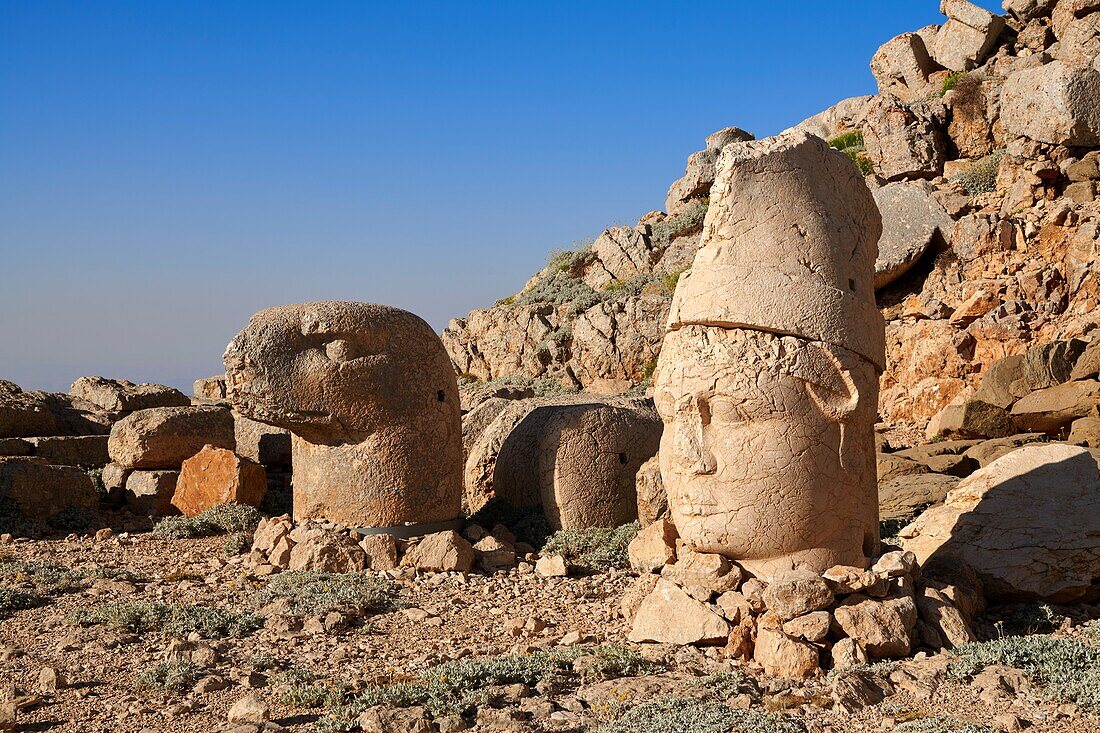 Statue heads,from right,Antiochus & Eagle in front of the stone pyramid 62 BC Royal Tomb of King Antiochus I Theos of Commagene,east Terrace,Mount Nemrut or Nemrud Dagi summit,near AdA±yaman,Turkey.