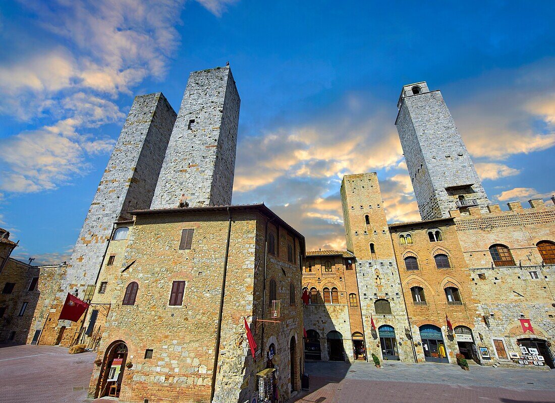 "The Piazza Duomo (Cathedral Square) of San Gimignano with its medieval towers built as defensive towers and also to show the families wealth by the height of the tower. A UNESCO World Heritage Site. San Gimignano; Tuscany Italy."