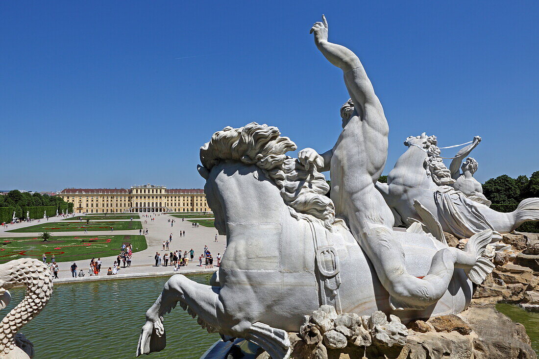 Figures of the Neptune Fountain with Schönbrunn Palace, Vienna, Austria