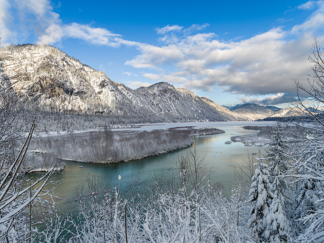 River Isar flowing into the frozen Sylvenstein Reservoir near Bad Tolz in the Karwendel mountain range during winter. Germany, Bavaria.