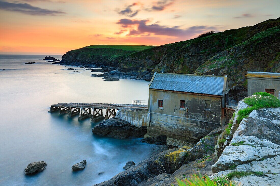 Sunset captured in March from Lizard Point in Cornwall,with the old lifeboat station as the main focal point.A long shutter speed was utilized to blur the movement in the water and clouds.