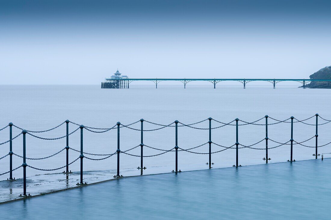 The Marine Lake at Clevedon with the Victorian pier in the Severn Estuary beyond. North Somerset,England.