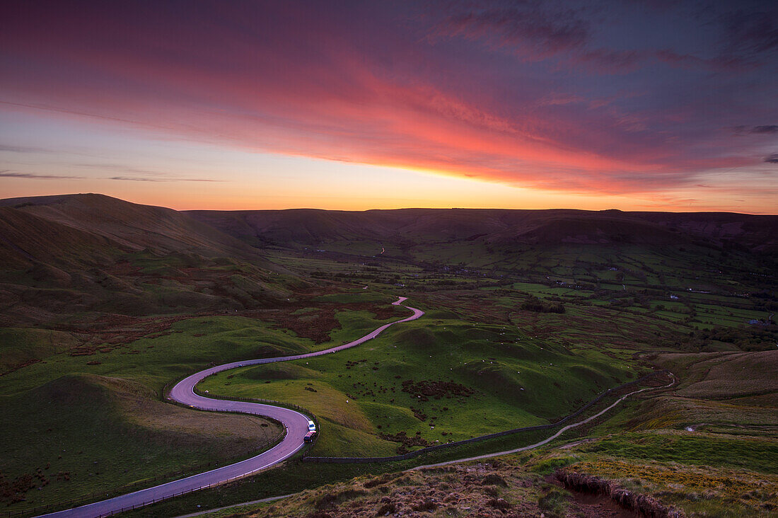 Spectacular sunset at Rushup Edge with winding road leading to Edale, Peak District, Derbyshire, England, United Kingdom, Europe